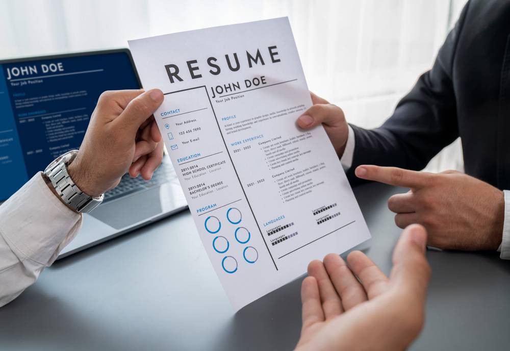 Top 10 Skills Your Resume Can Benefit From 1 person holding resume piece paper scaled